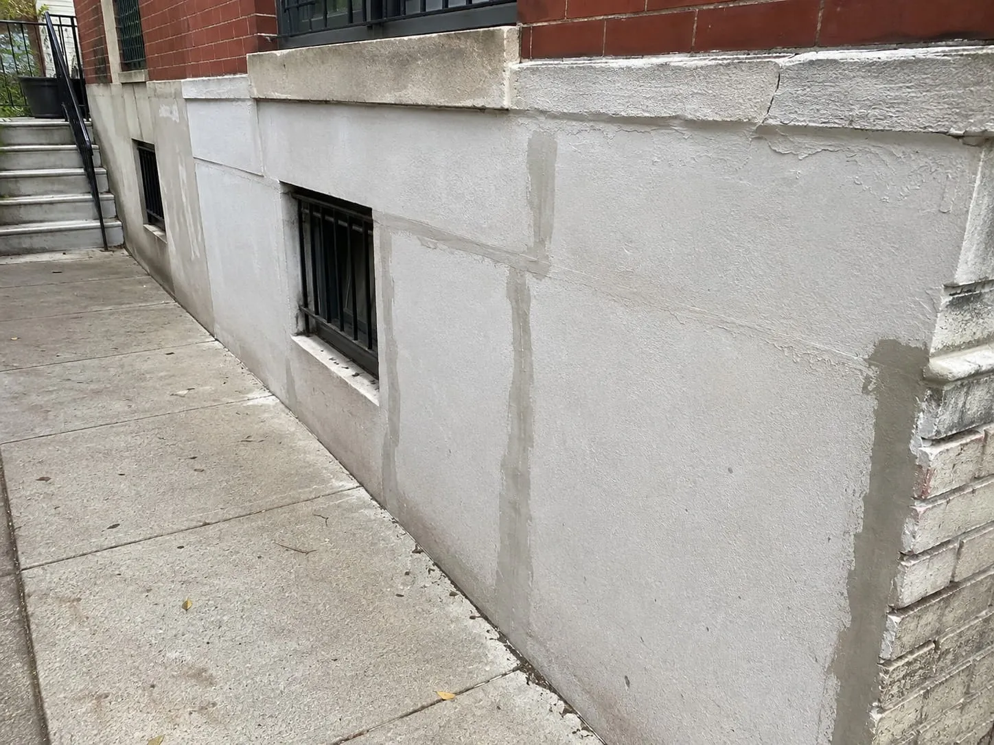 Repaired structural cracks patched across the foundation wall of a Washington DC rowhouse