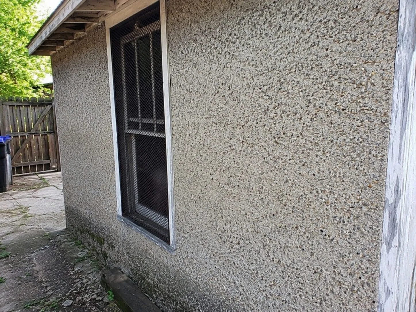 Close view of a pebbled dash stucco finish on a Washington DC exterior wall